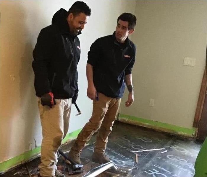 Two SERVPRO technicians getting ready to fix water damage on floor