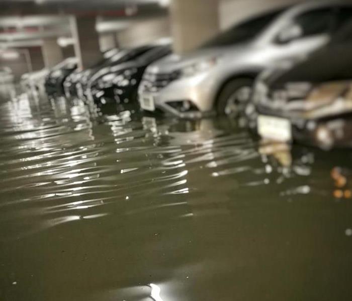Parking garage with cars under water from a flood. 