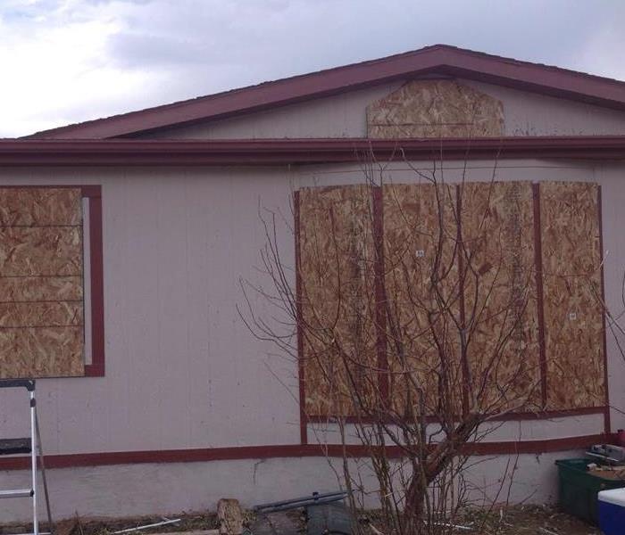 Flood, boarded-up home